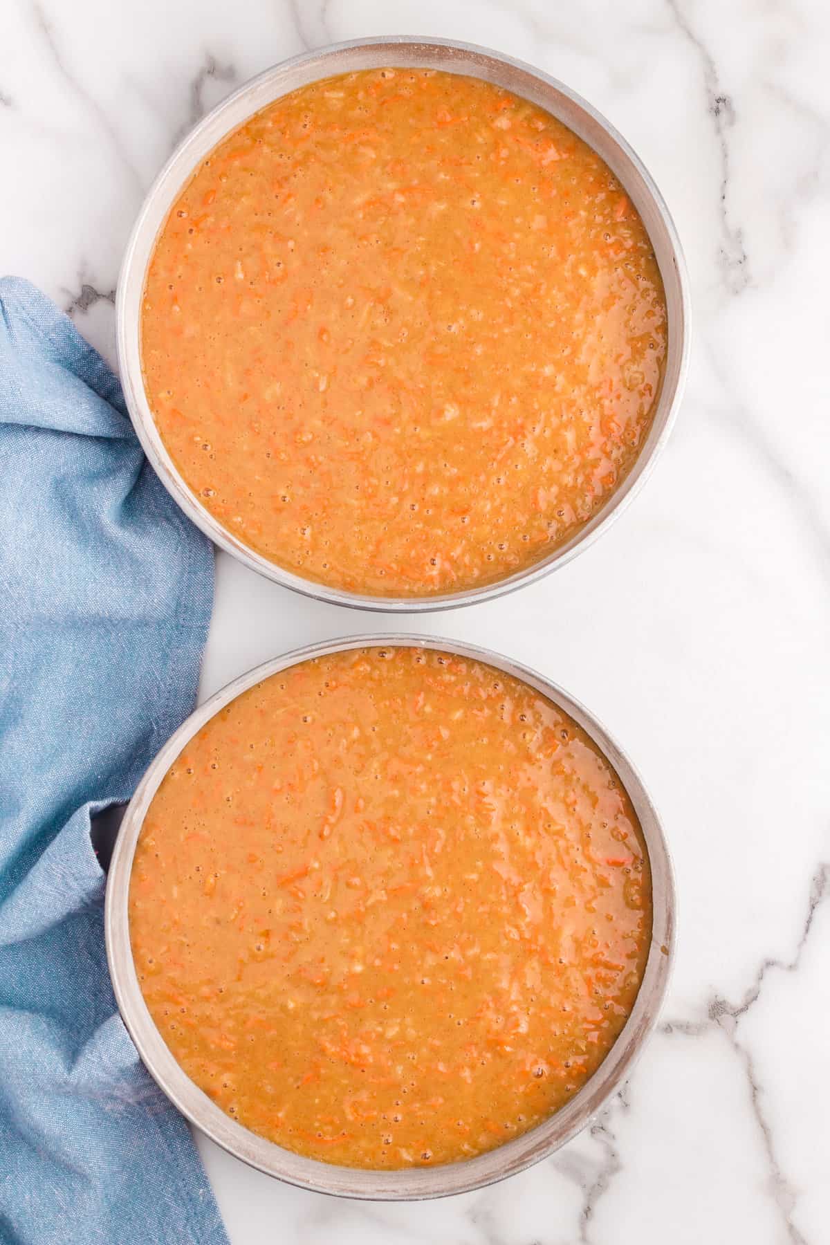Pouring Carrot Cake Batter into Two Round Cake Pans