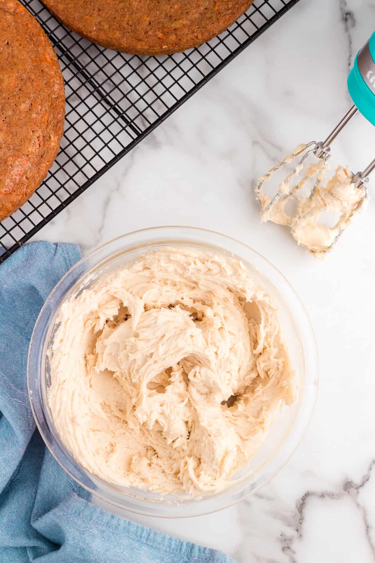 Using hand mixer to combine ingredients for cream cheese frosting for Carrot Cake Recipe