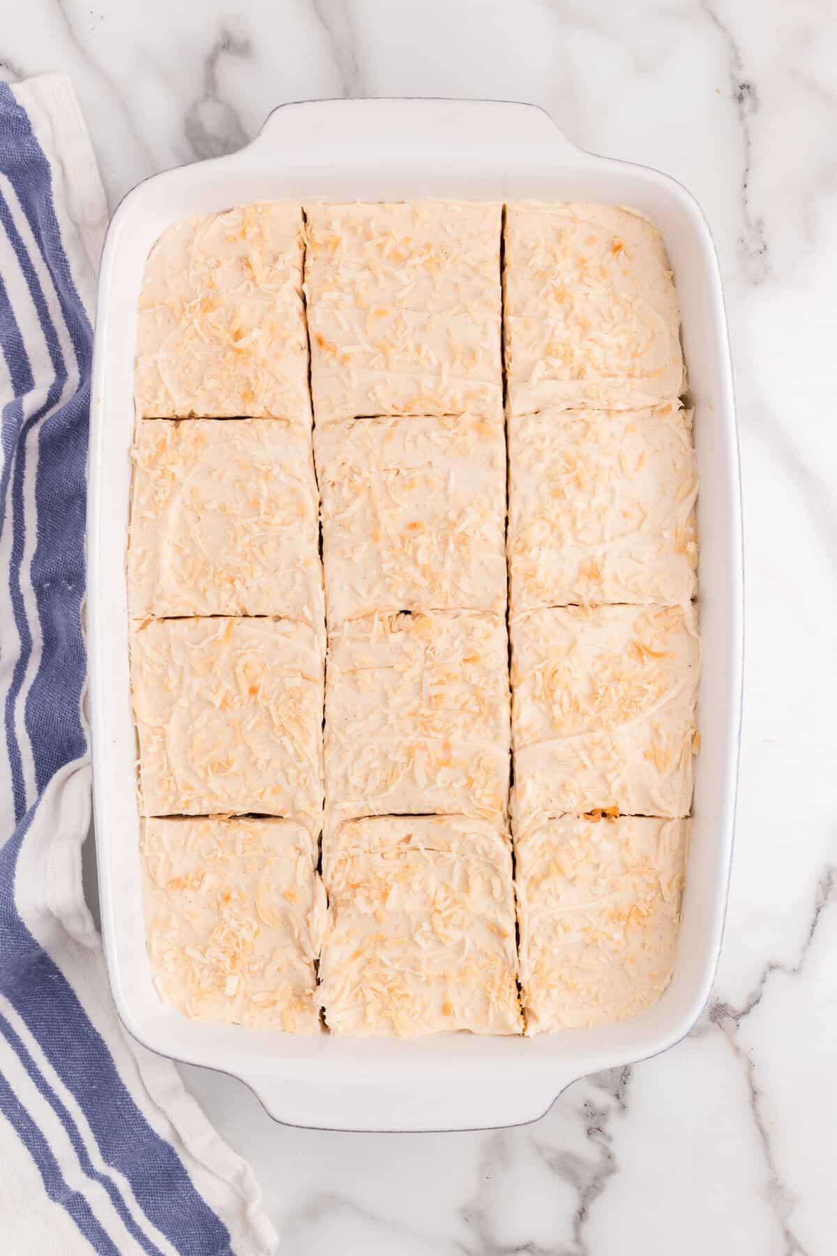 Cutting Carrot Poke Cake into even square in 9x13 pan