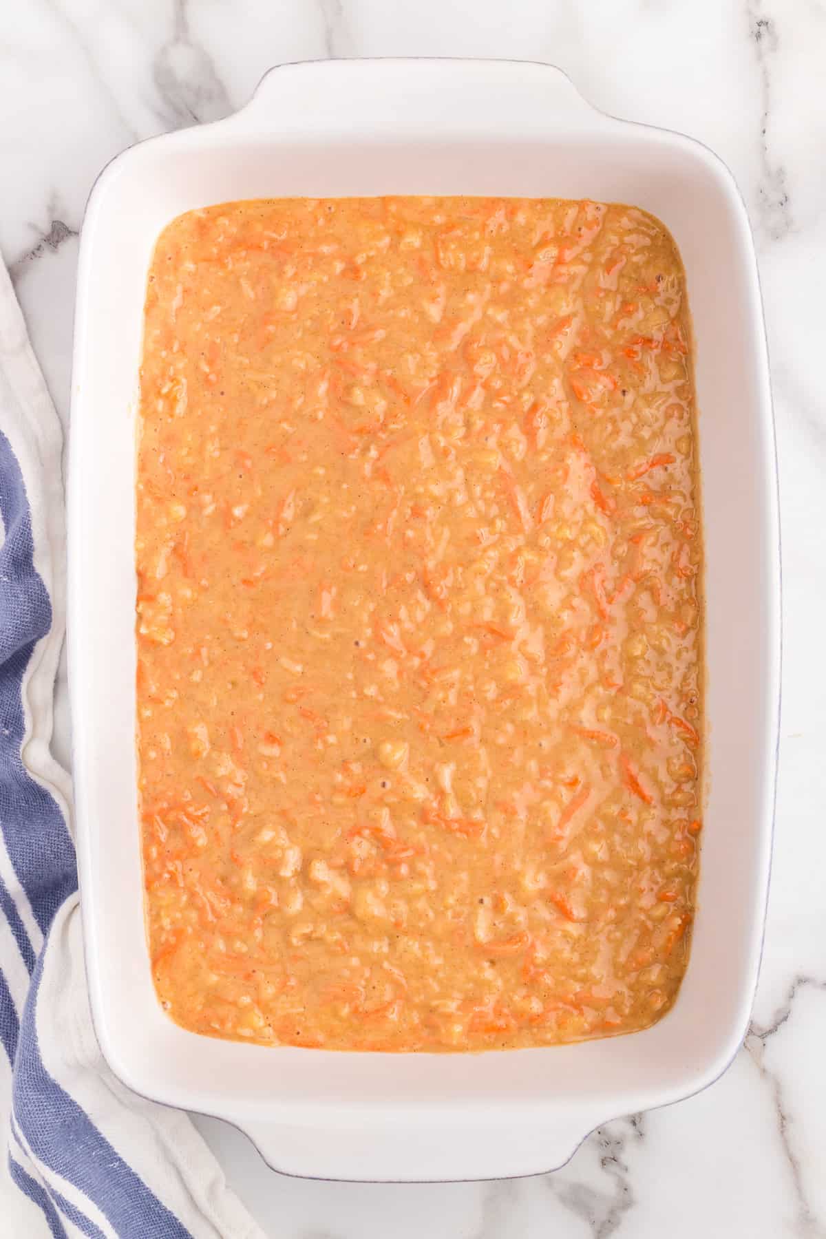 Carrot Poke Cake batter poured into 9x13 baking dish