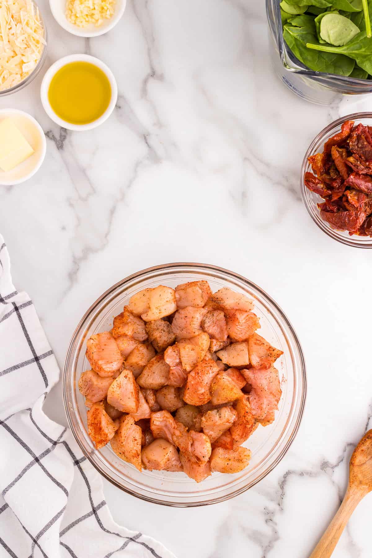 Chicken coated in seasonsing for Creamy Tuscan Chicken Pasta recipe