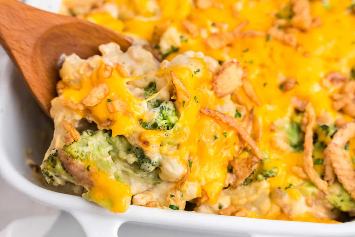 Broccoli Cauliflower Casserole in baking dish with wooden spoon