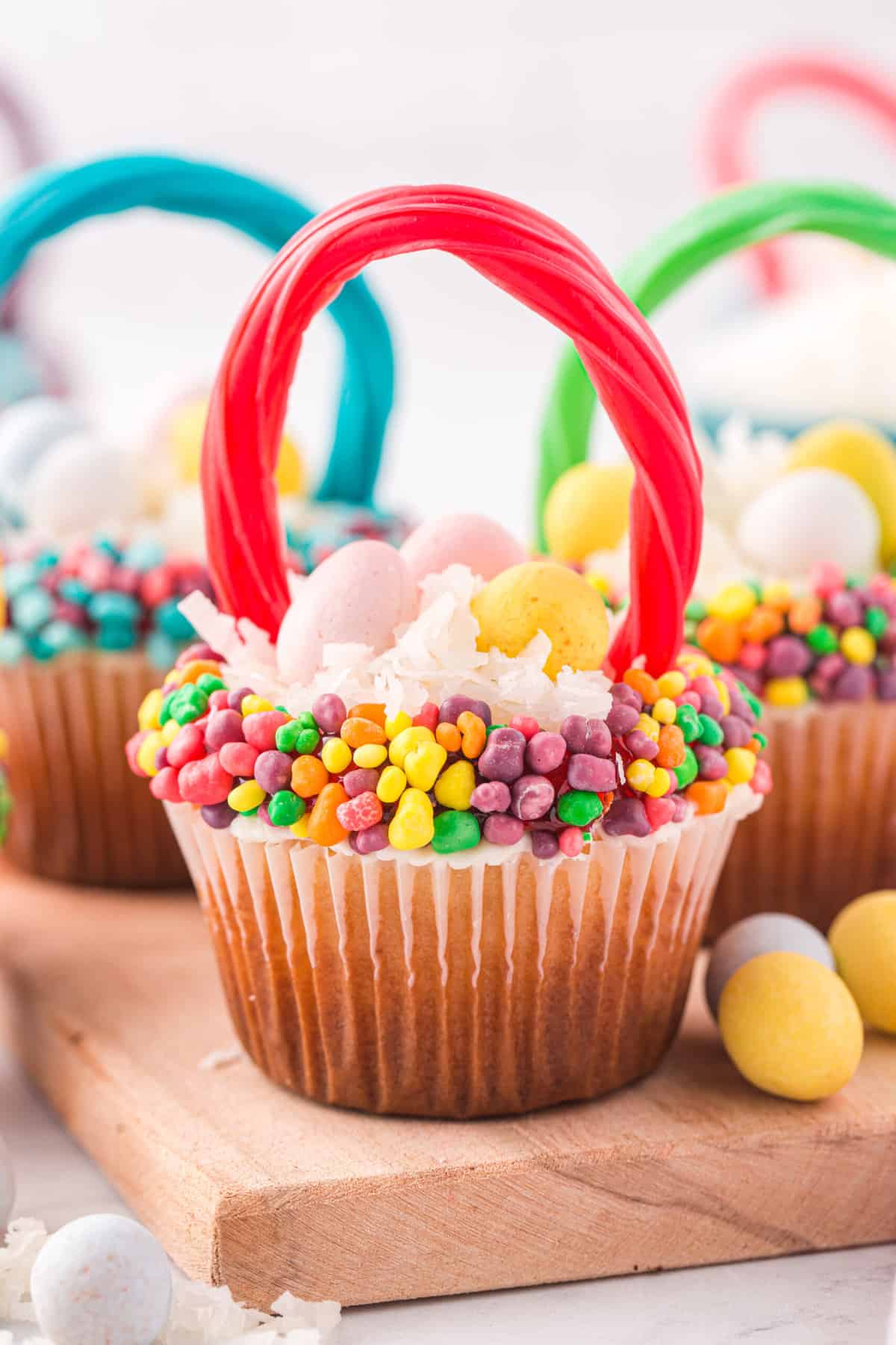 Cupcake Completed displayed on a cutting board with more cupcakes in the background.