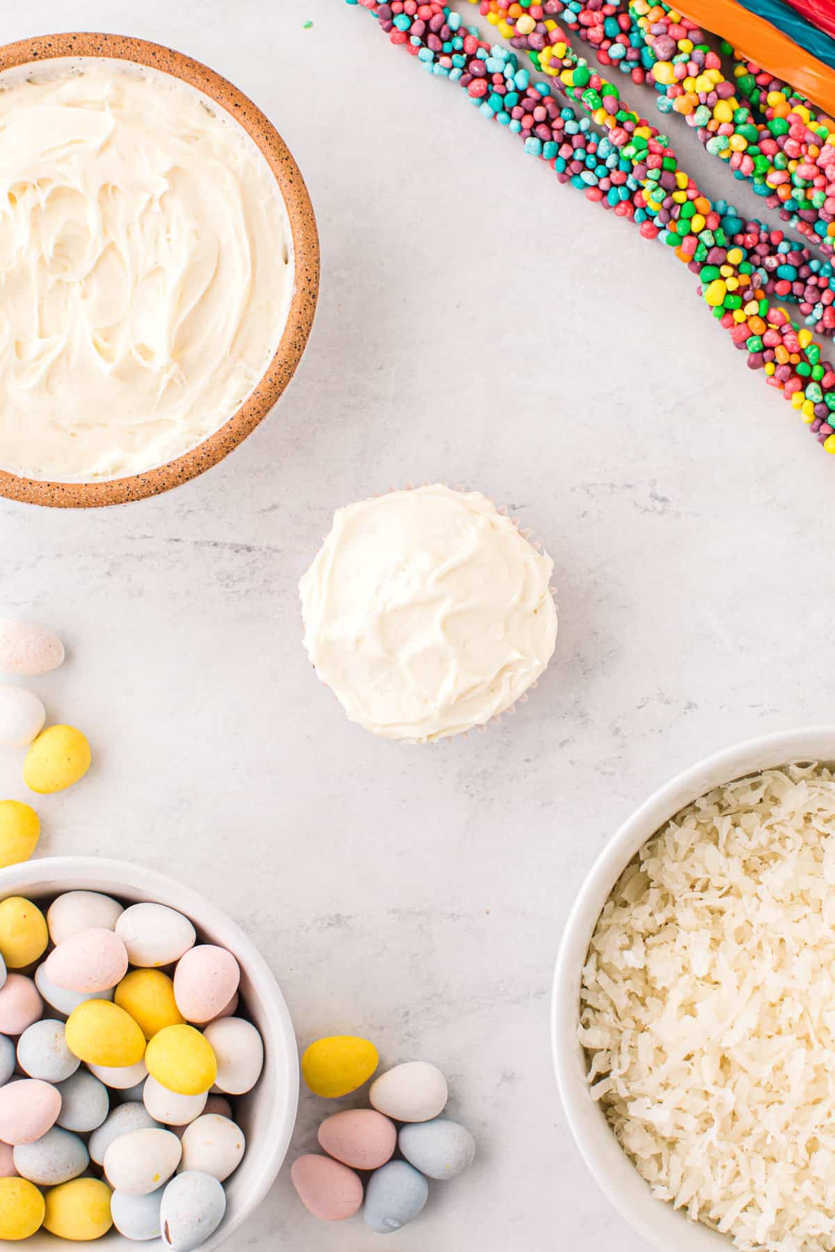 Once baked, frost the top of the cupcake with vanilla frosting.