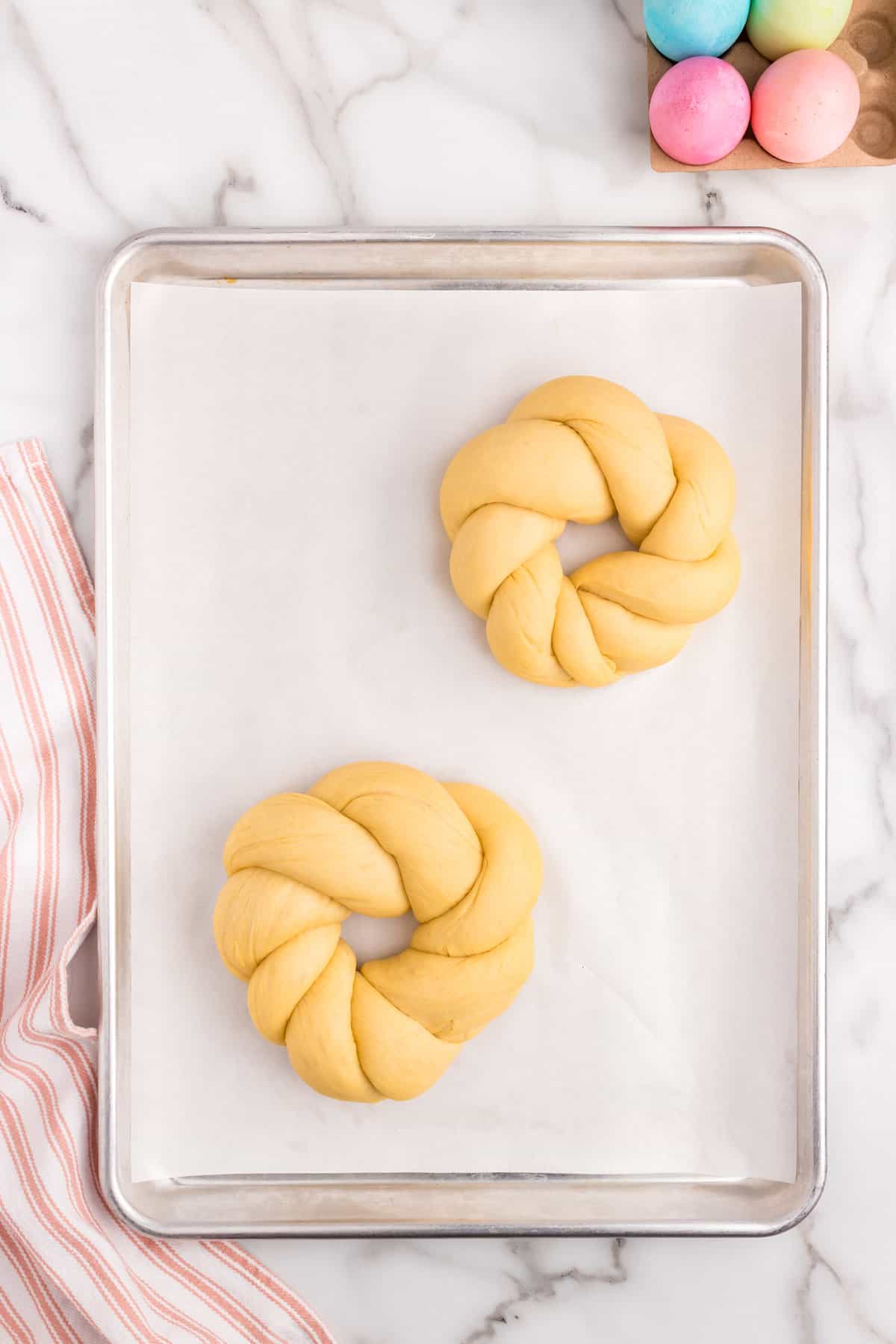 Adding Italian Easter Bread to parchment lined baking sheet