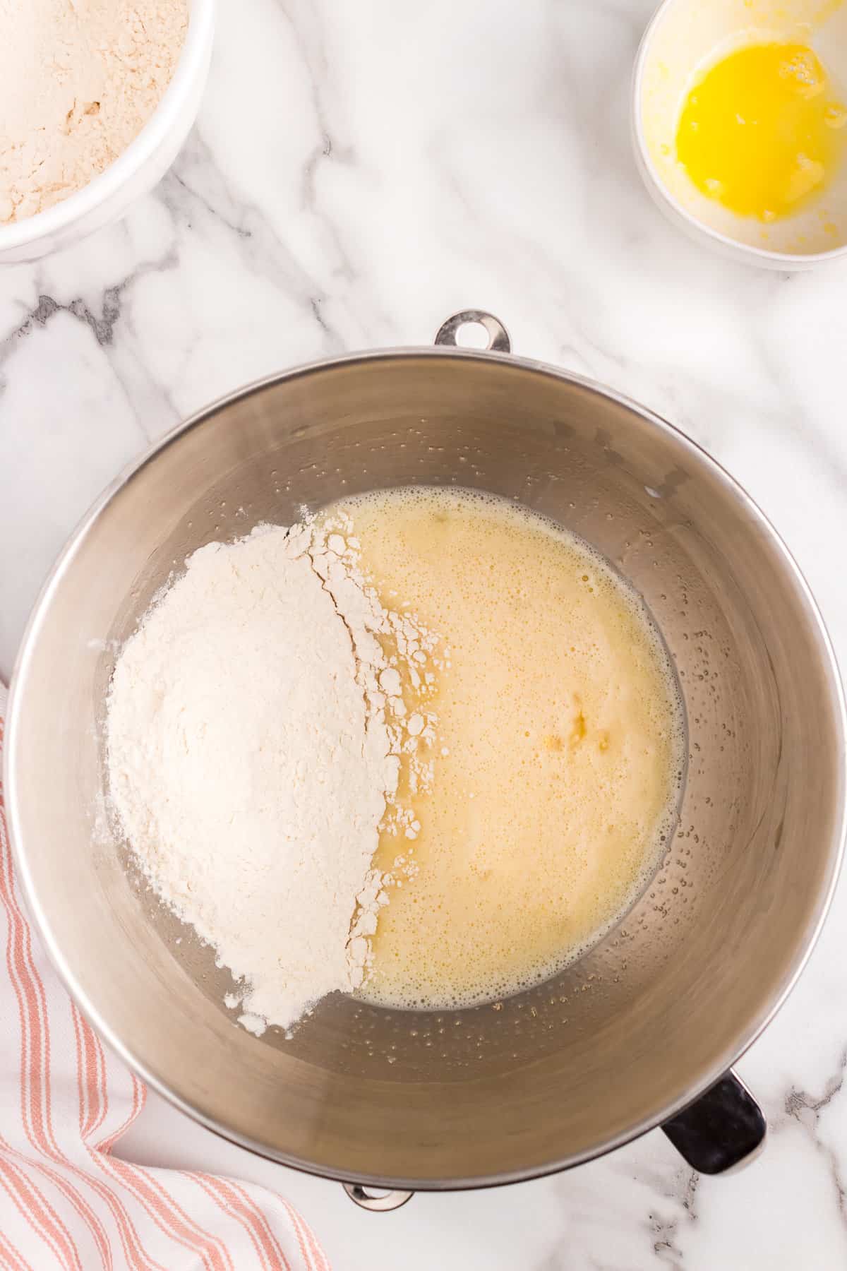 Adding flour and dry yeast to mixing bowl for Italian Easter Bread recipe