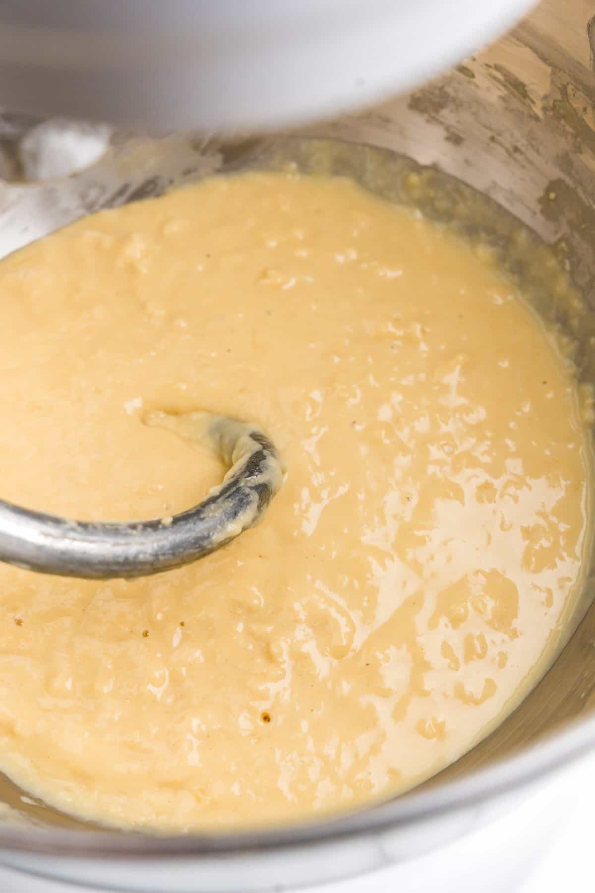 Attaching dough hook in stand mixer with dough ingredients for Easter Bread in bowl