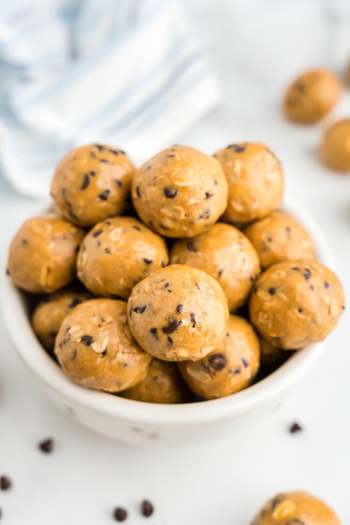 a white bowl filled with energy balls.