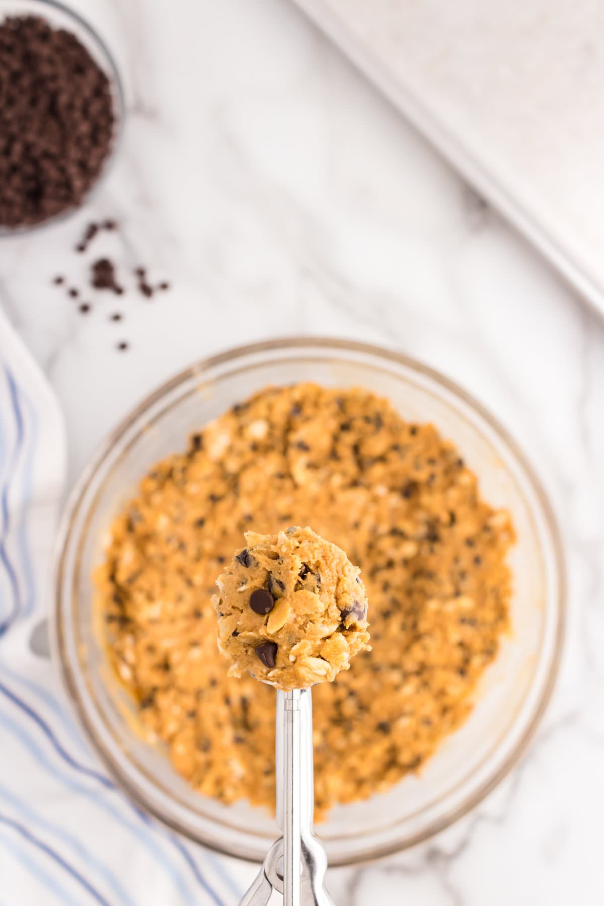 Using a cookie scoop, scoop out energy ball mix & roll into balls.