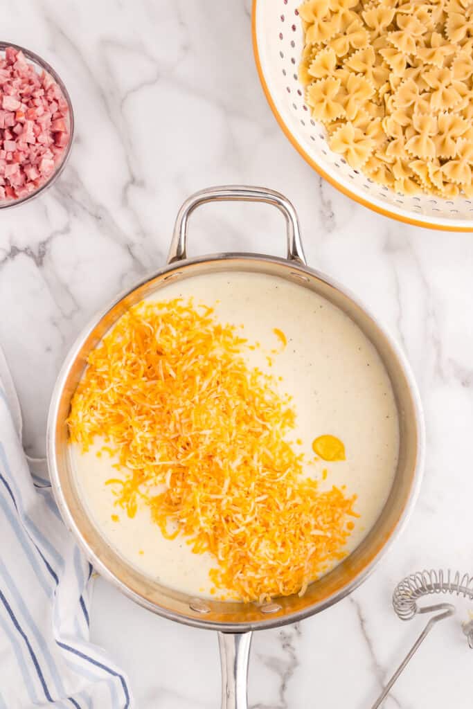 Added shredded cheese to saucepan for Cheesy Ham Casserole recipe