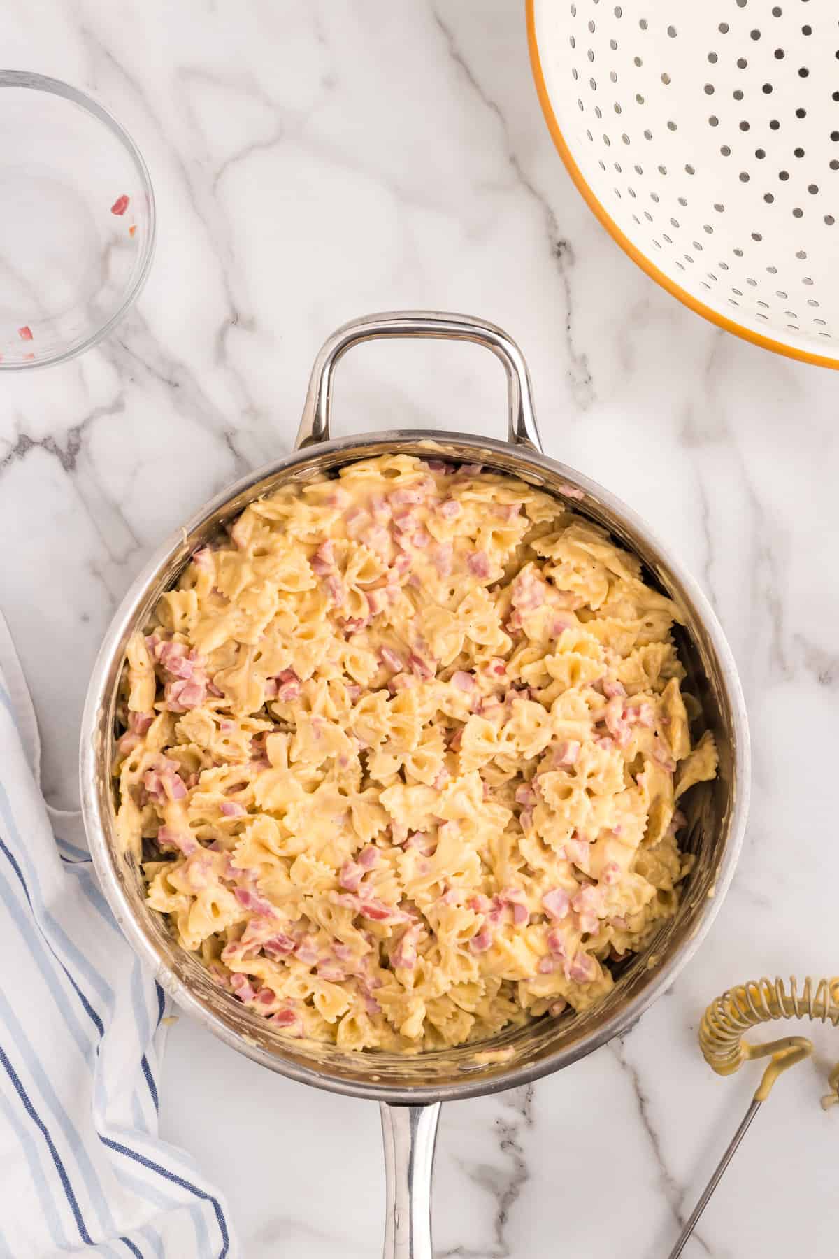 Combined Cheesy Ham Casserole ingredients in skillet