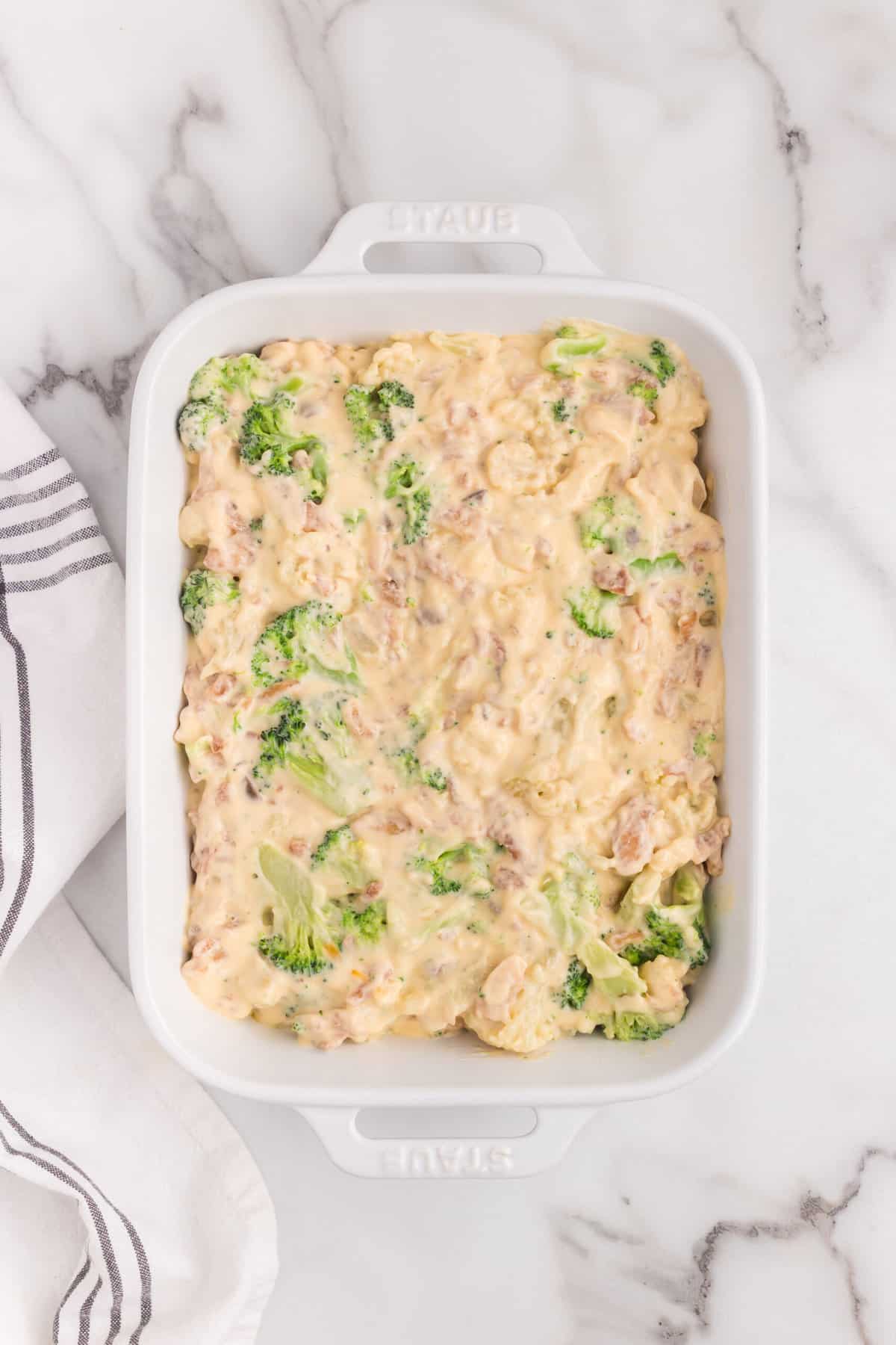 Spreading Broccoli Cauliflower Casserole mixture in 9x13 baking pan