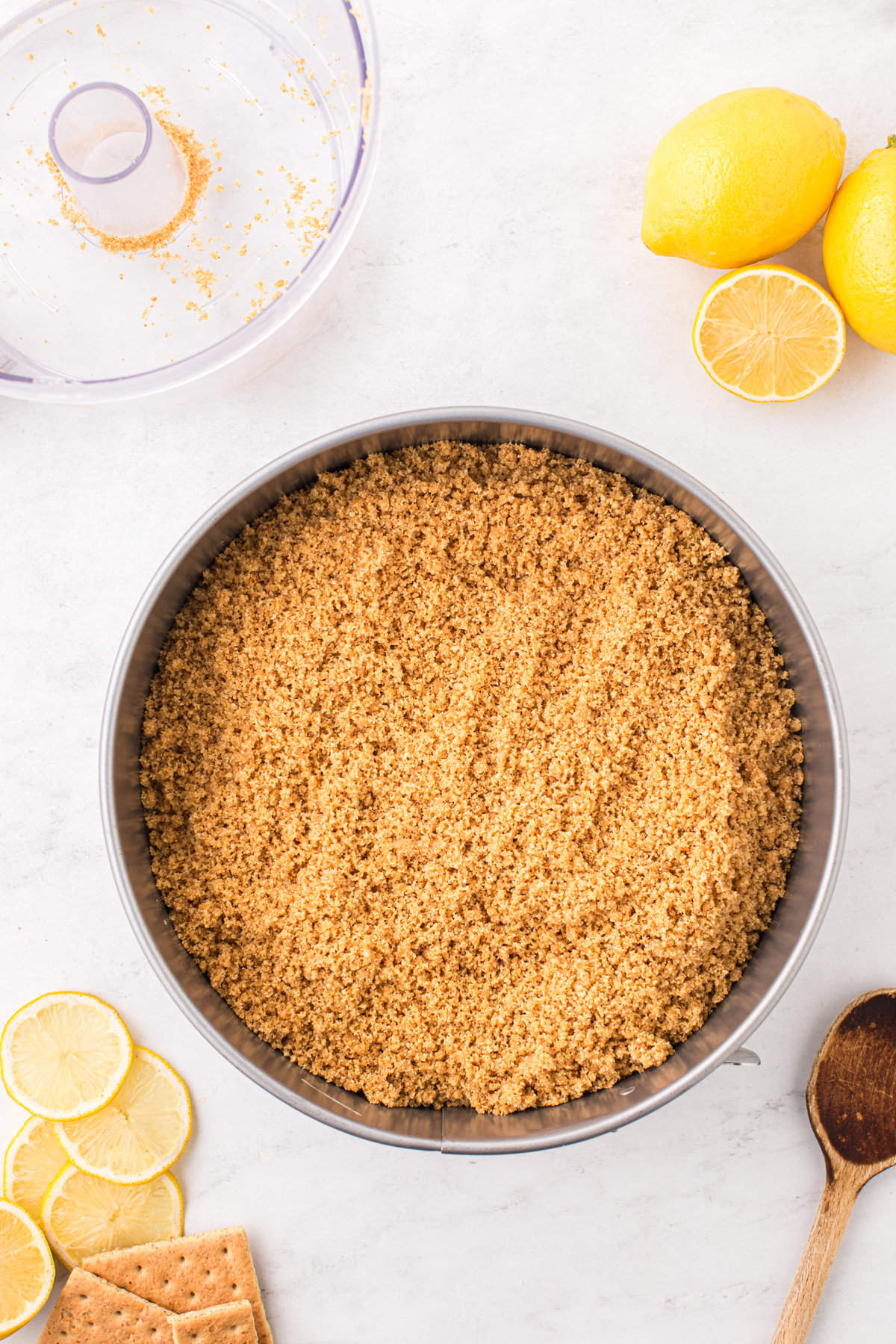 Lining springform pan with graham cracker crust for Lemon Cheesecake recipe