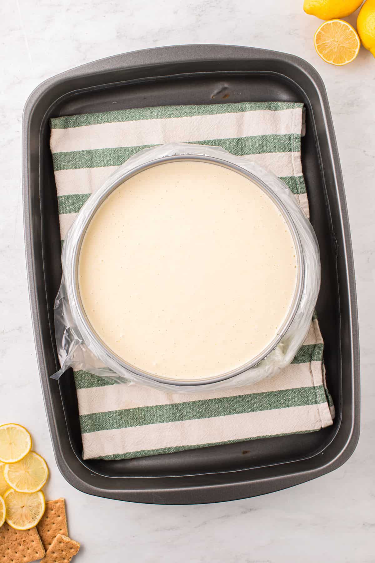 Adding Lemon Cheesecake filling atop crust in springform pan