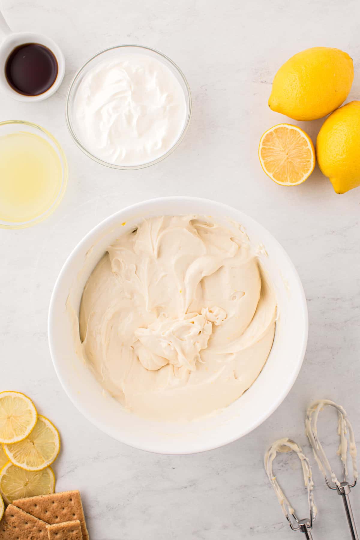 Perfectly blended Adding softened cream cheese block to mixed Lemon Cheesecake ingredients in mixing bowl
