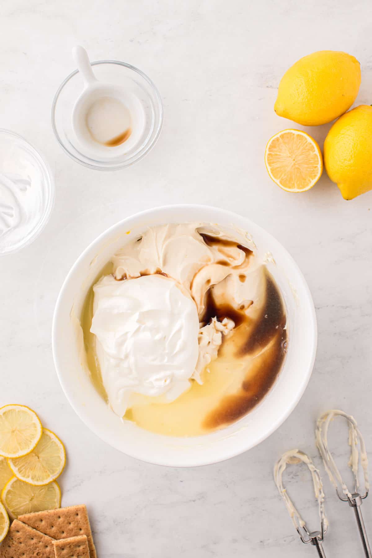 Adding more ingredients to Lemon Cheesecake filling in mixing bowl