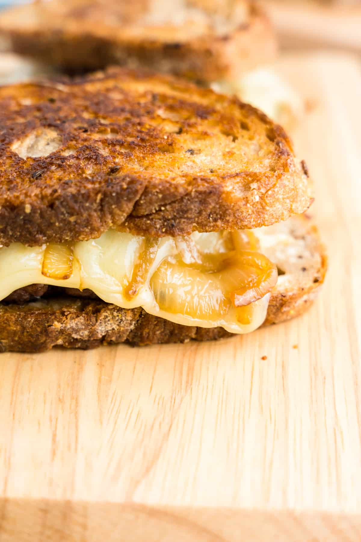 Cooked Patty Melt on wooden cutting board