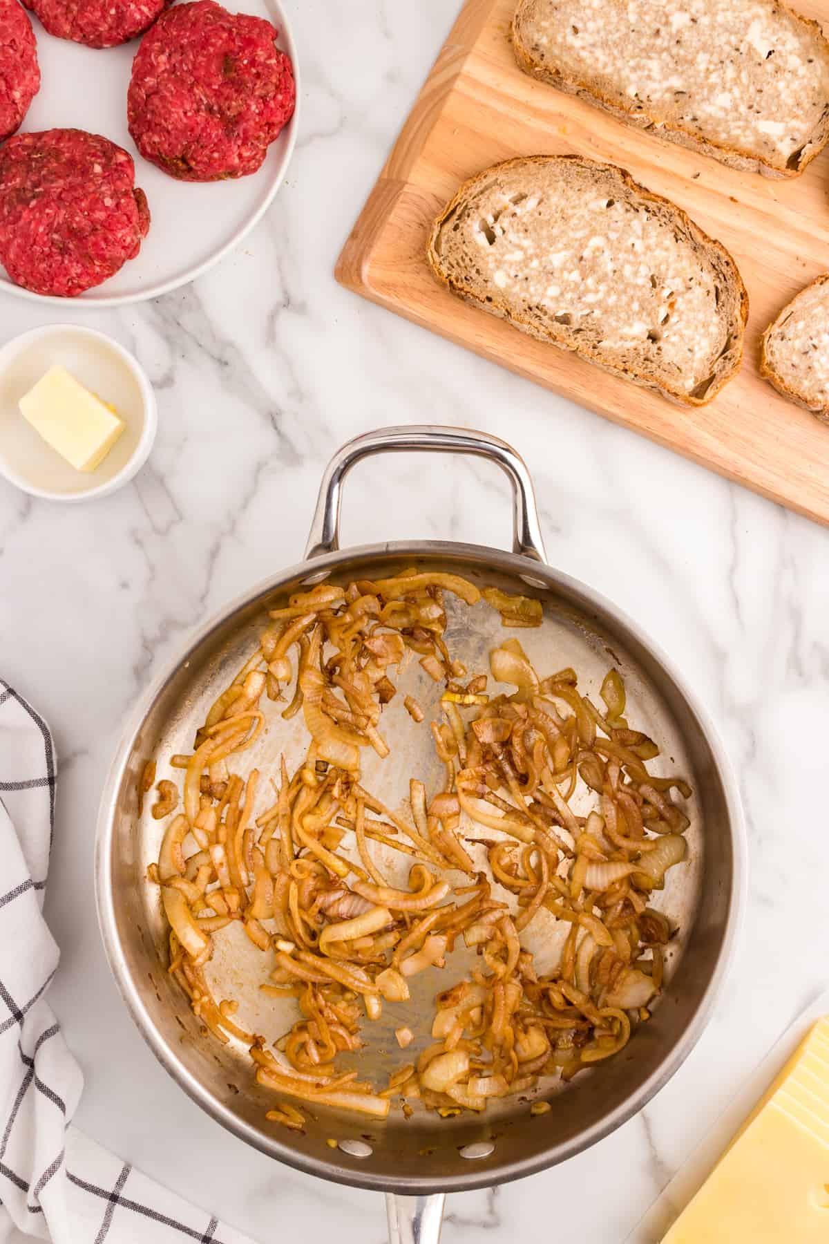 Cooking onions in stovetop skillet for Patty Melts