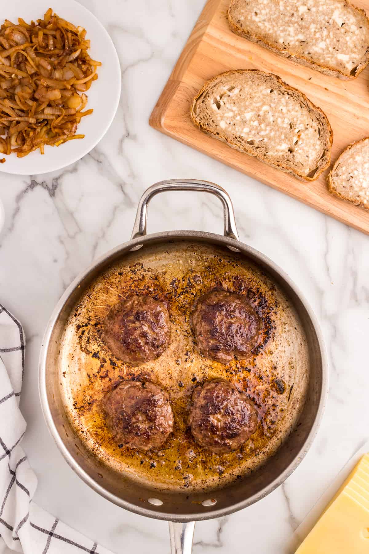 Cooked seasoned hamburger patties for Patty Melt recipe