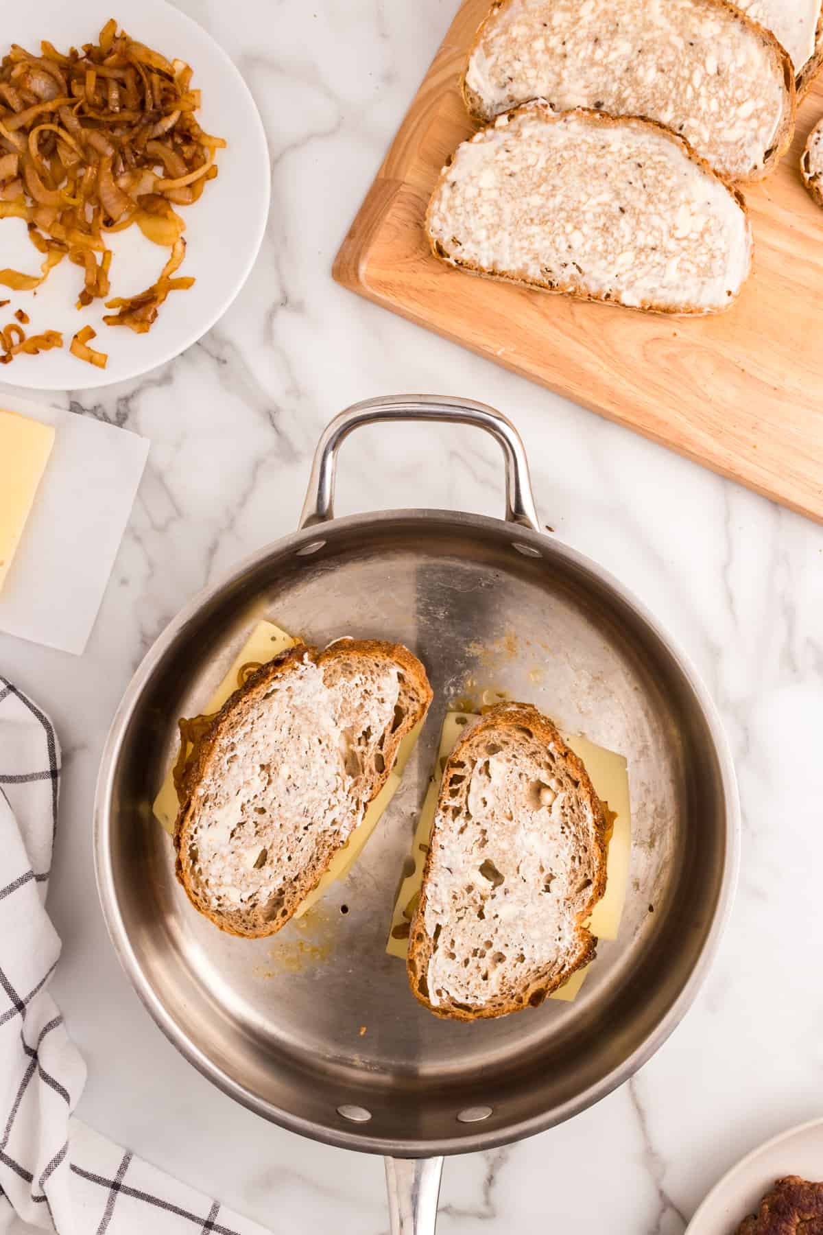 Spreading mayo on other side of rye bread for Patty Melts