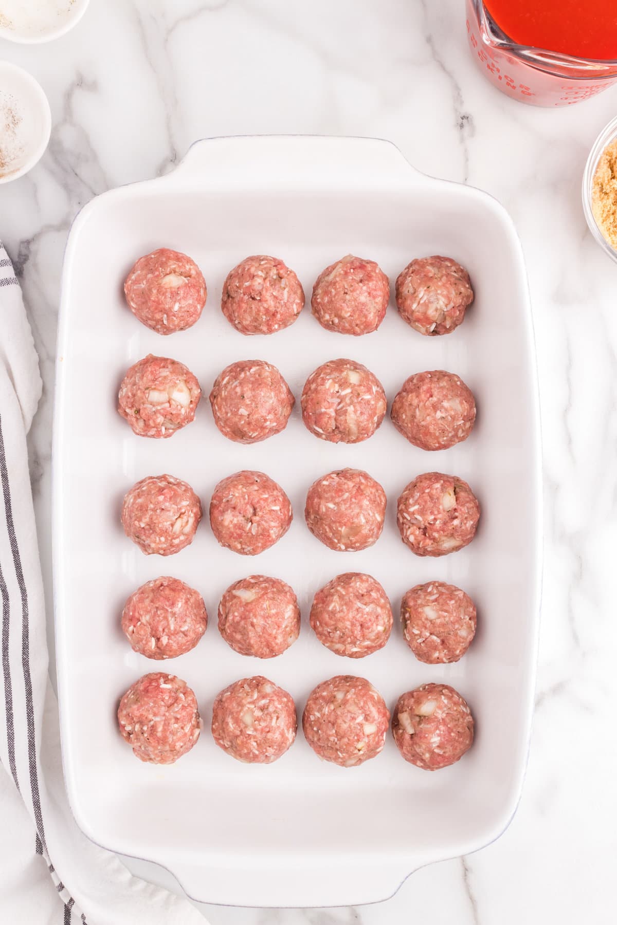 Porcupine Meatballs formed into balls and arranged in a 9x13 baking pan