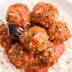 Porcupine Meatballs on a bed of rice in a serving bowl with a fork