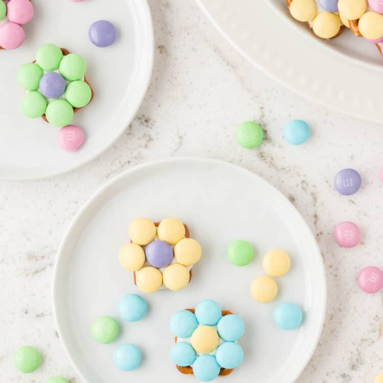 Two small white plates with Flower Pretzel Bites on them.