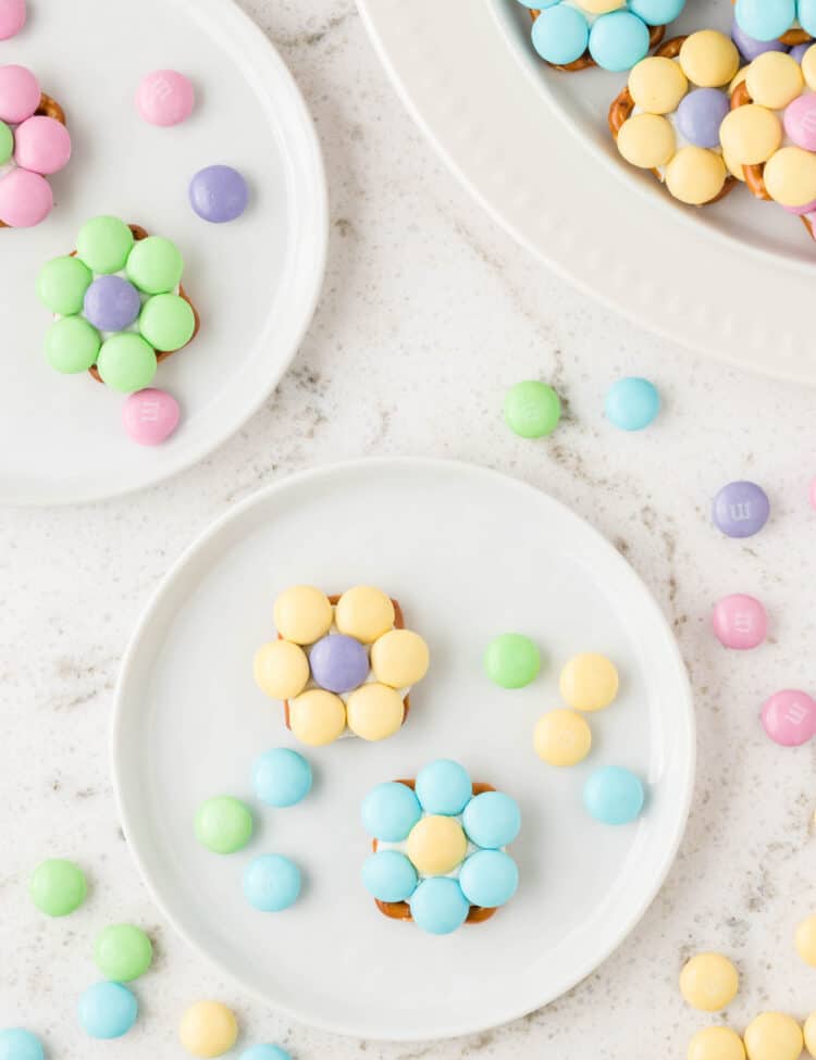 Two small white plates with Flower Pretzel Bites on them.