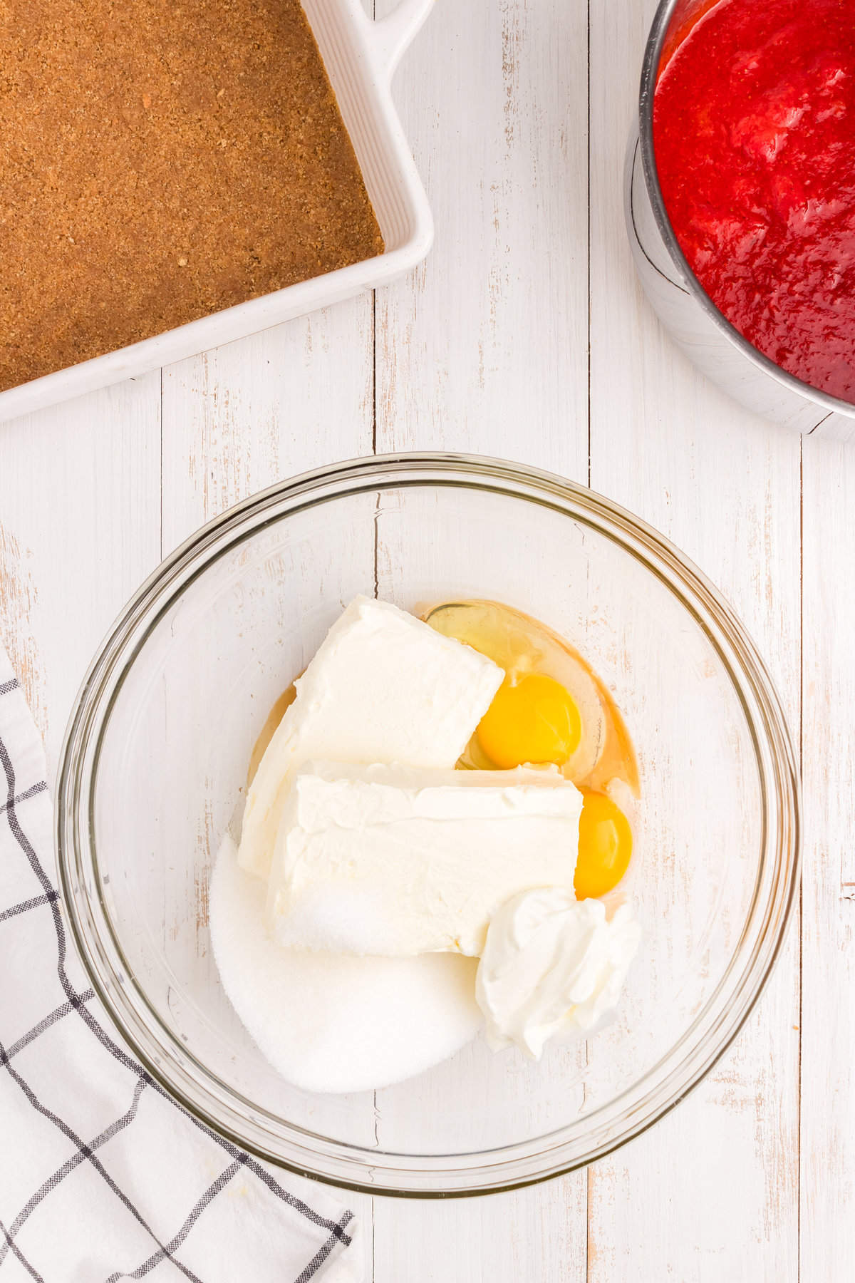 Ingredients for cheesecake in mixing bowl for Strawberry Cheesecake Bars recipe