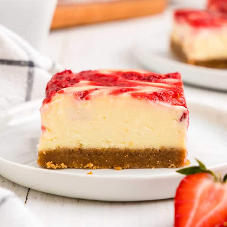 Strawberry Cheesecake Bars cut into square on plate