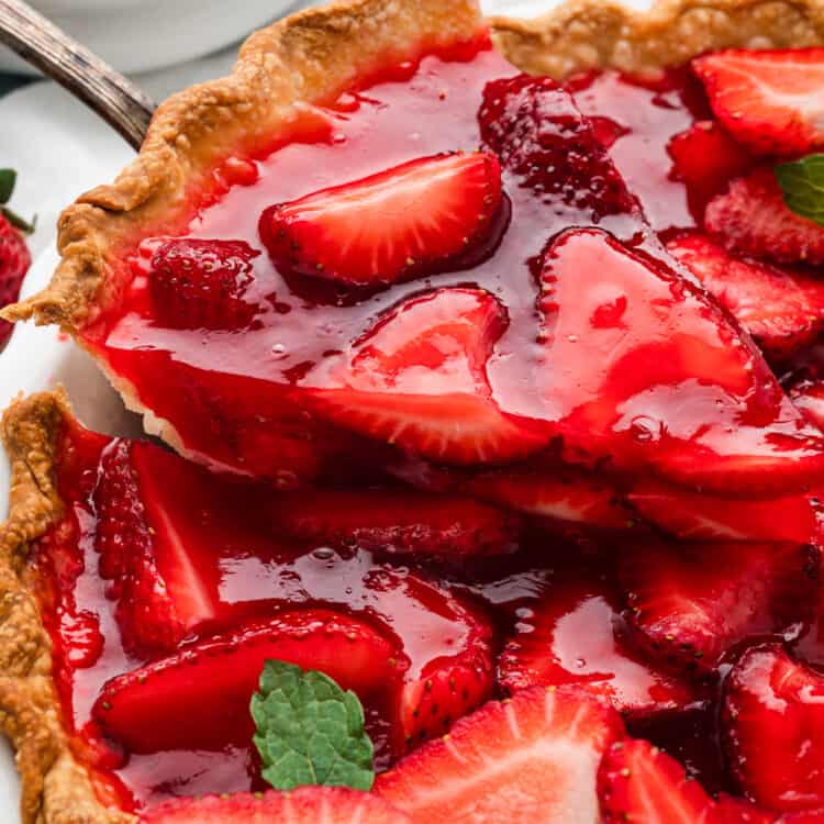 Easy Strawberry Pie cut into pieces with one being scooped out of pie pan