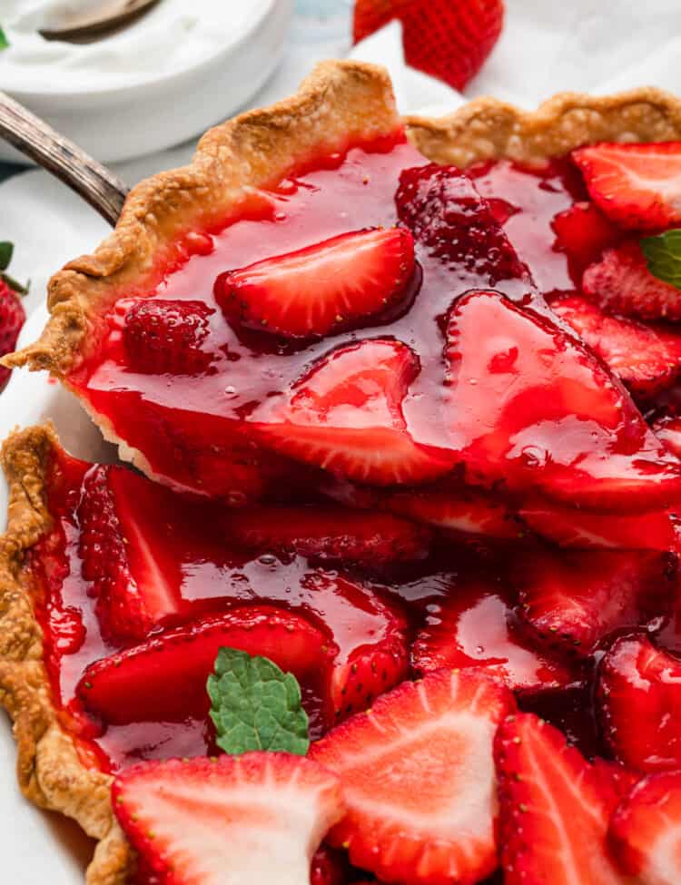Easy Strawberry Pie cut into pieces with one being scooped out of pie pan