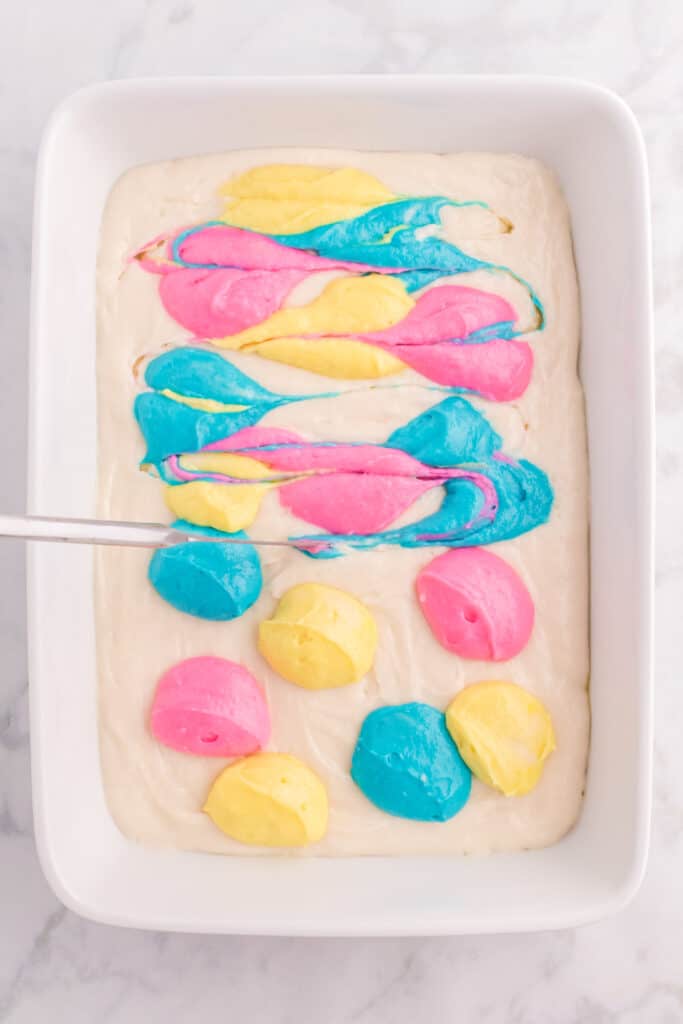 Take a knife and swirl the the color into the white cake batter.