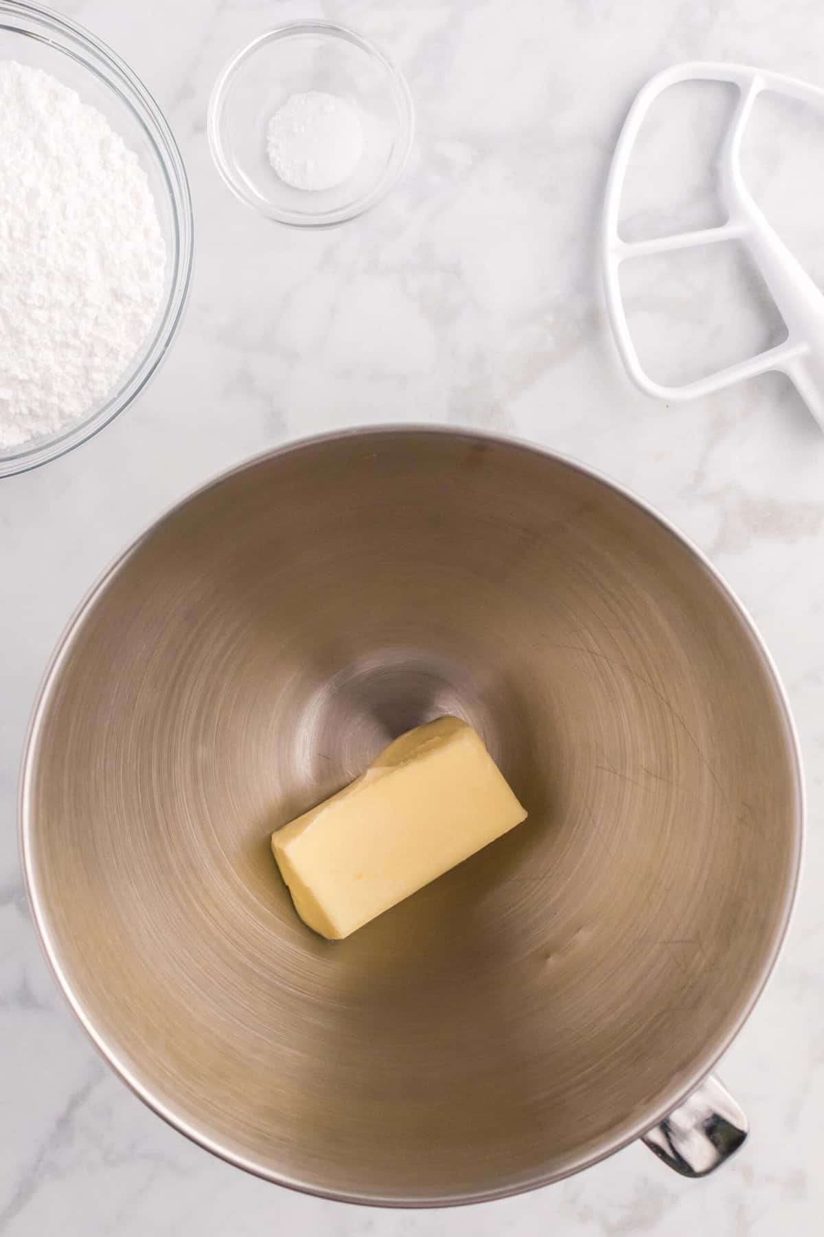 For the frosting, whip the softened butter in a mixing bowl.