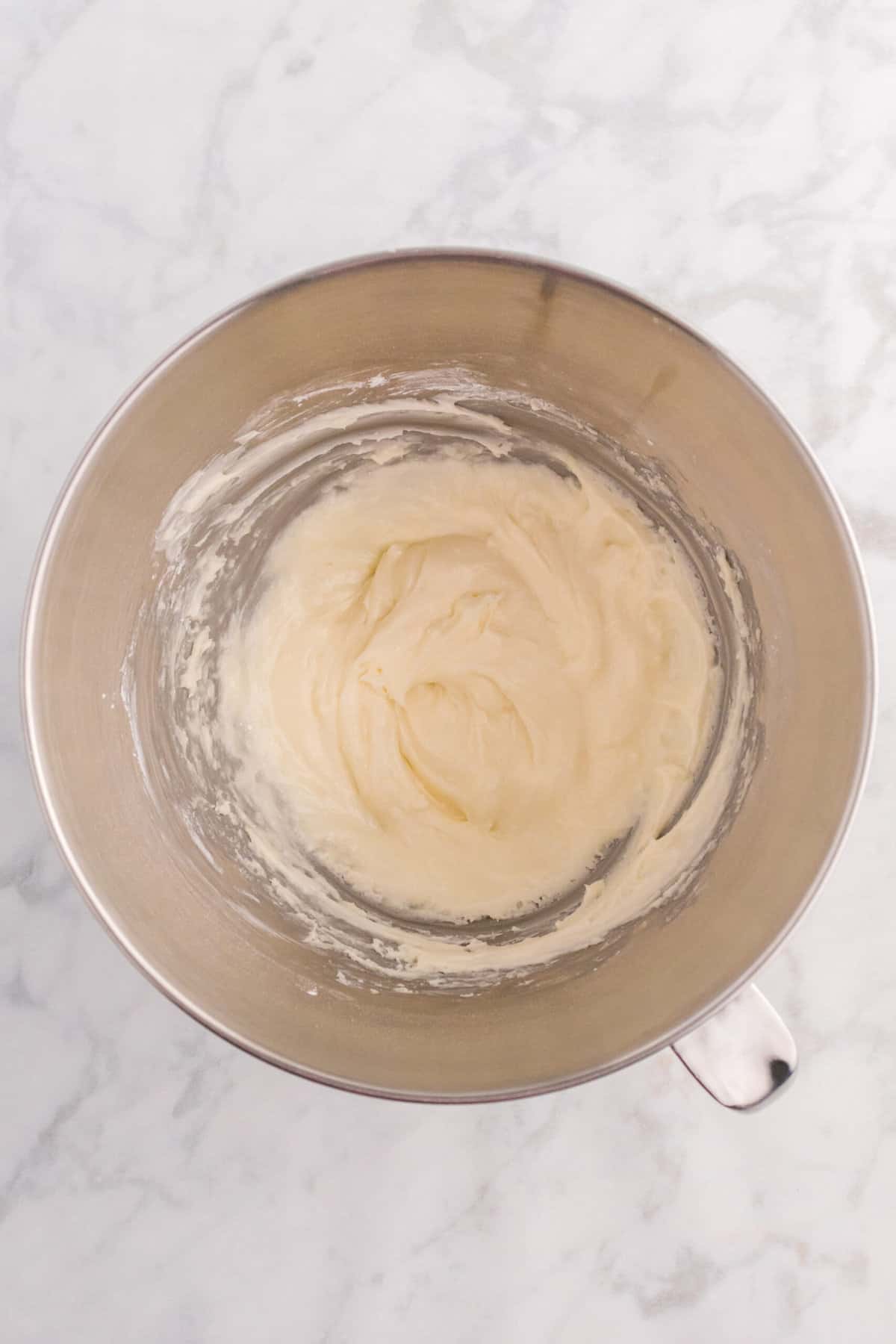 Add in the vanilla extract and 2 tablespoons of cream. Whip for another minute.