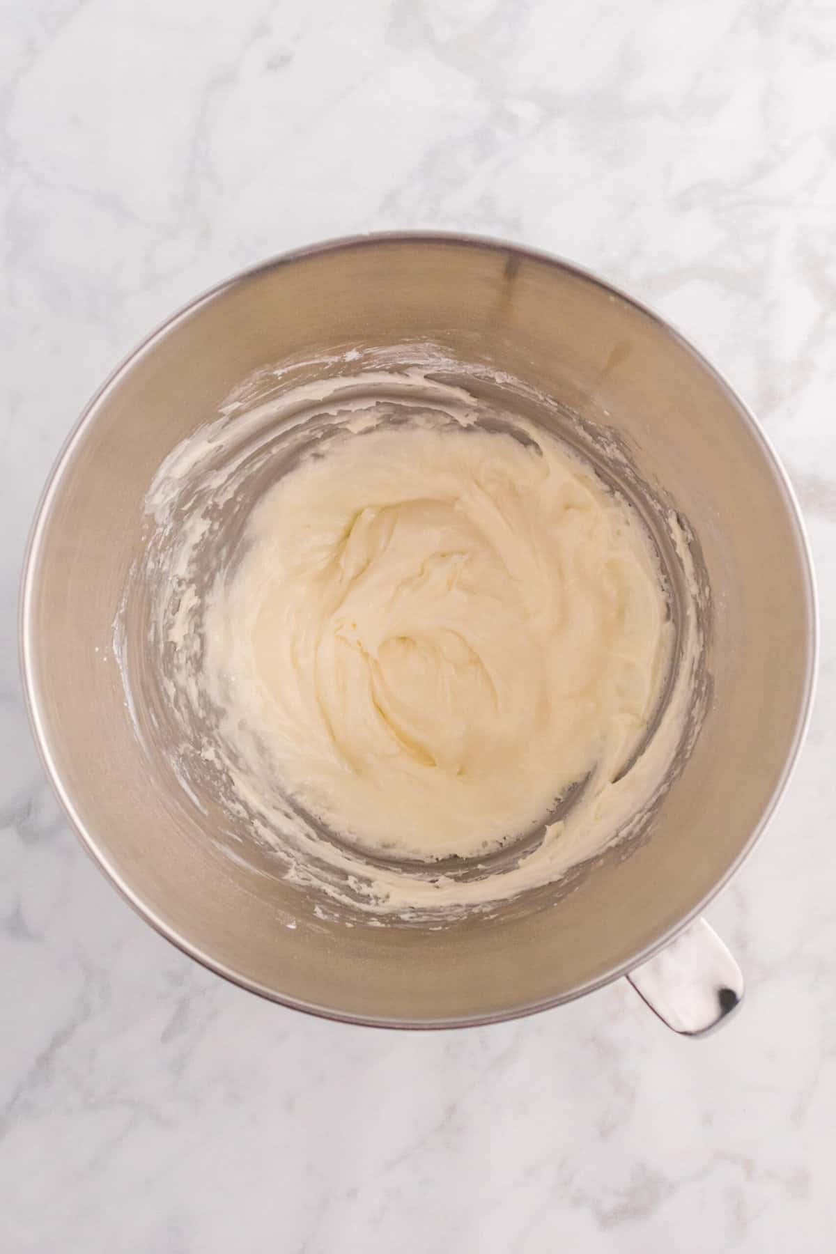 Add in the vanilla extract and 2 tablespoons of cream. Whip for another minute.