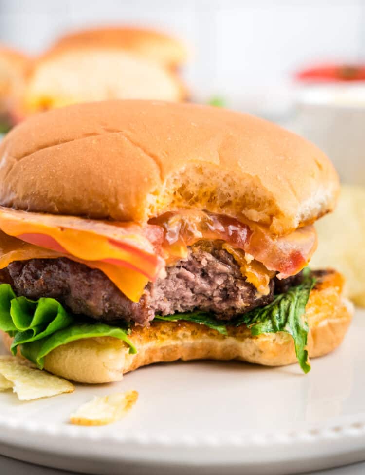 Loaded Baked Hamburger on plate with one bite taken