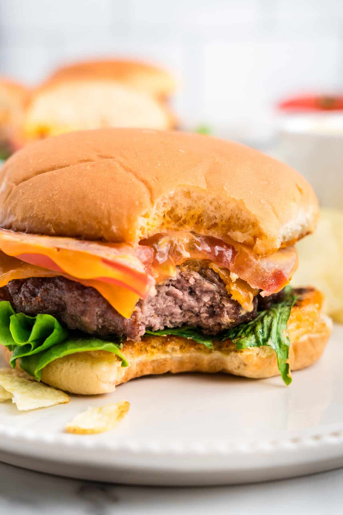 Loaded Baked Hamburger on plate with one bite taken