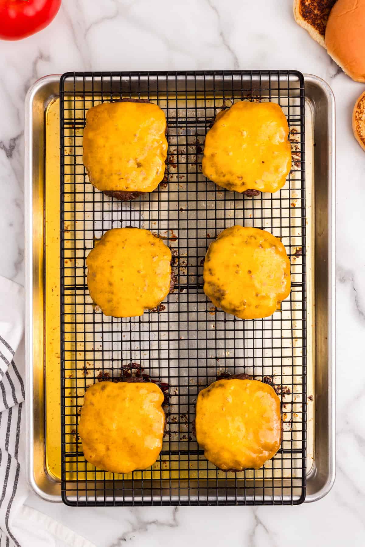 Melted cheddar cheese atop Baked Hamburgers