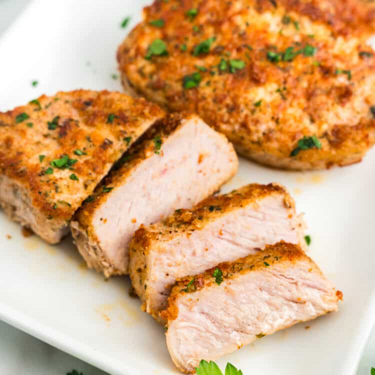 Parmesan Crusted Pork Chops sliced and arranged on serving plate