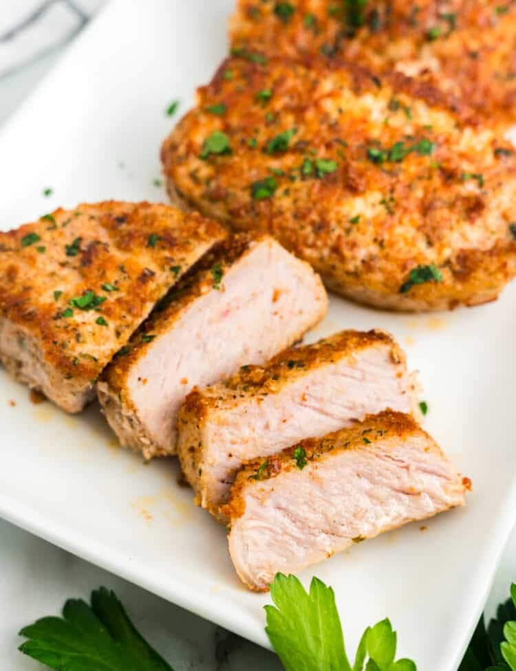 Parmesan Crusted Pork Chops sliced and arranged on serving plate