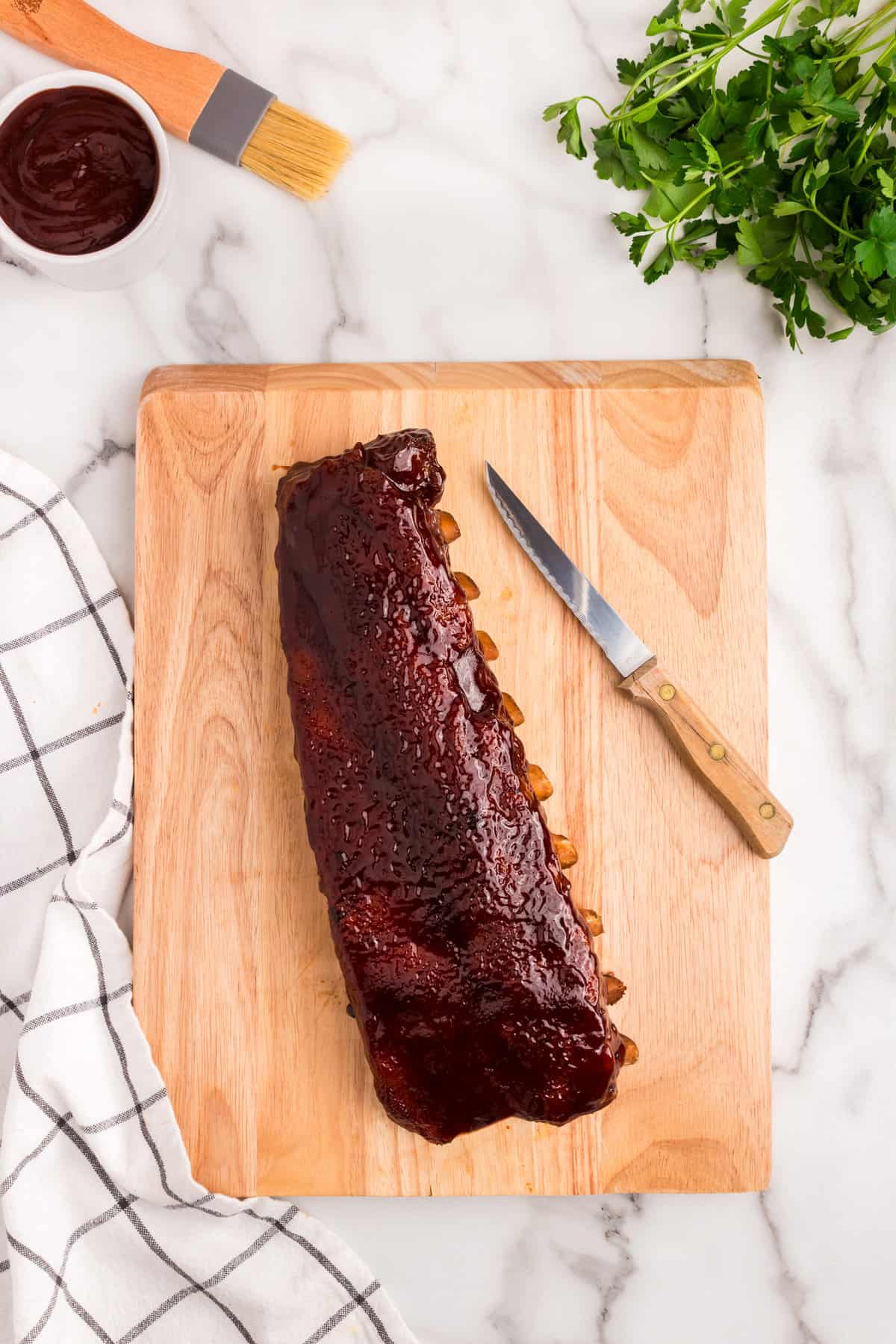 Oven Baked Ribs on wooden cutting board, ready to slice