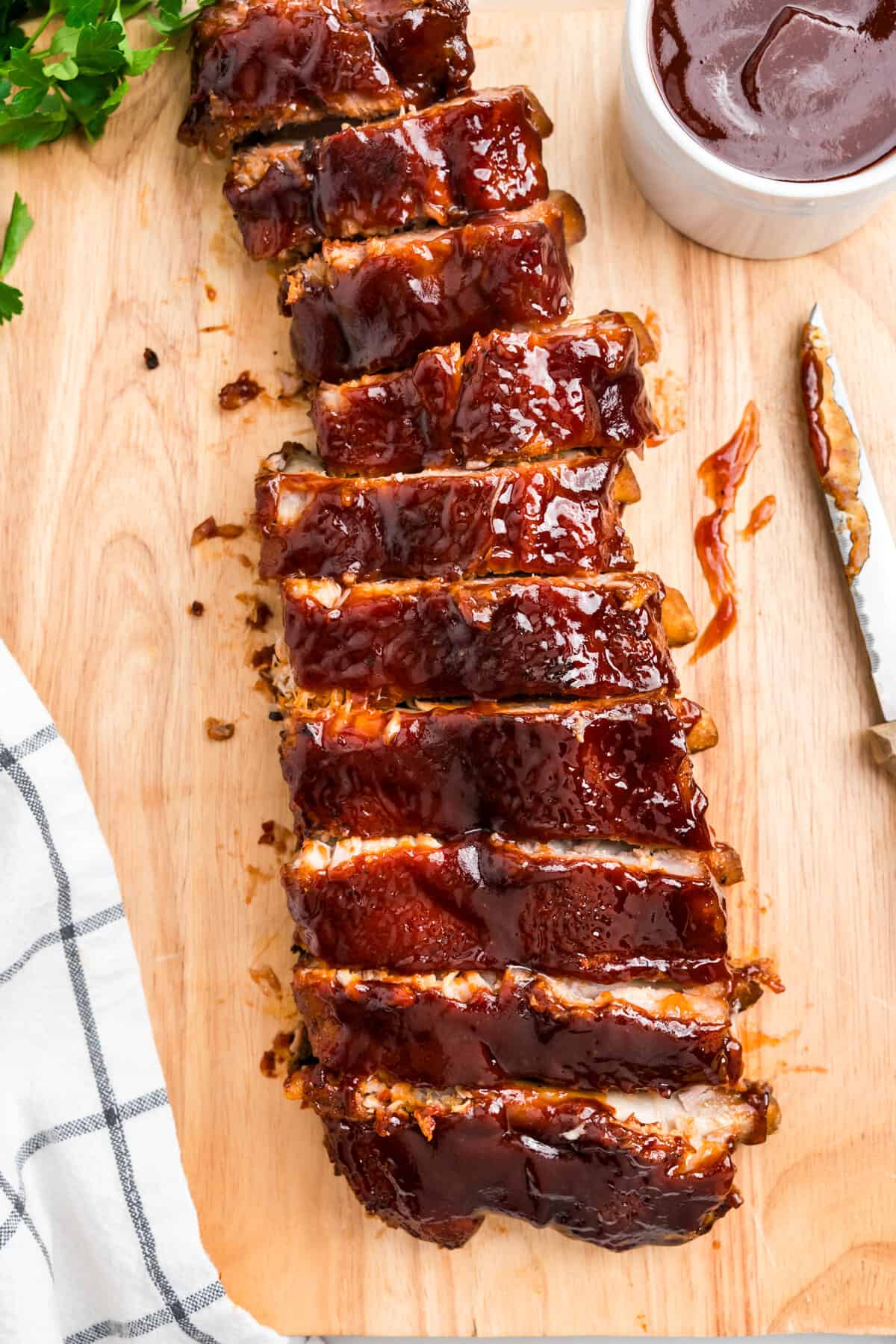 Sliced Oven Baked Pork Ribs on wooden cutting board