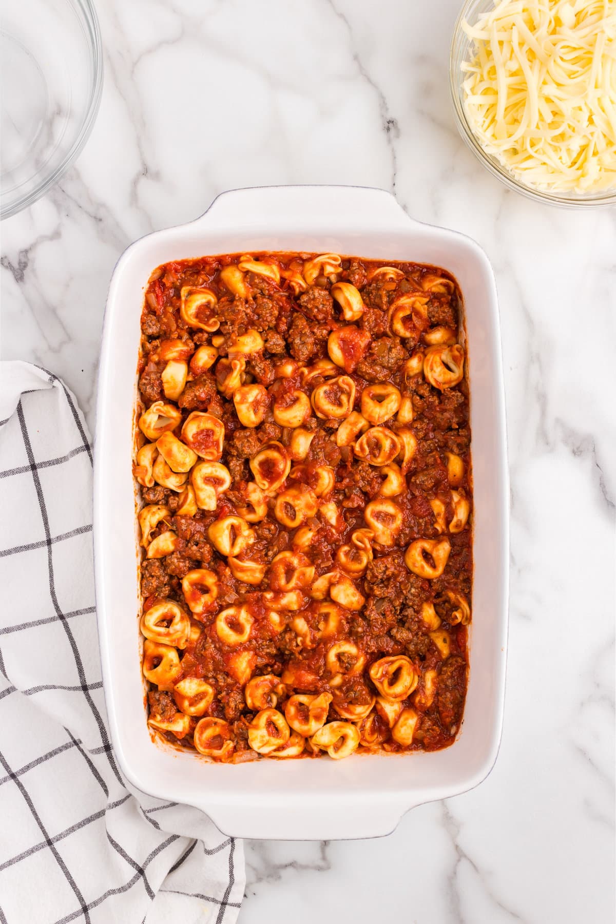 Combining ingredients for Baked Tortellini in 9x13 baking dish 