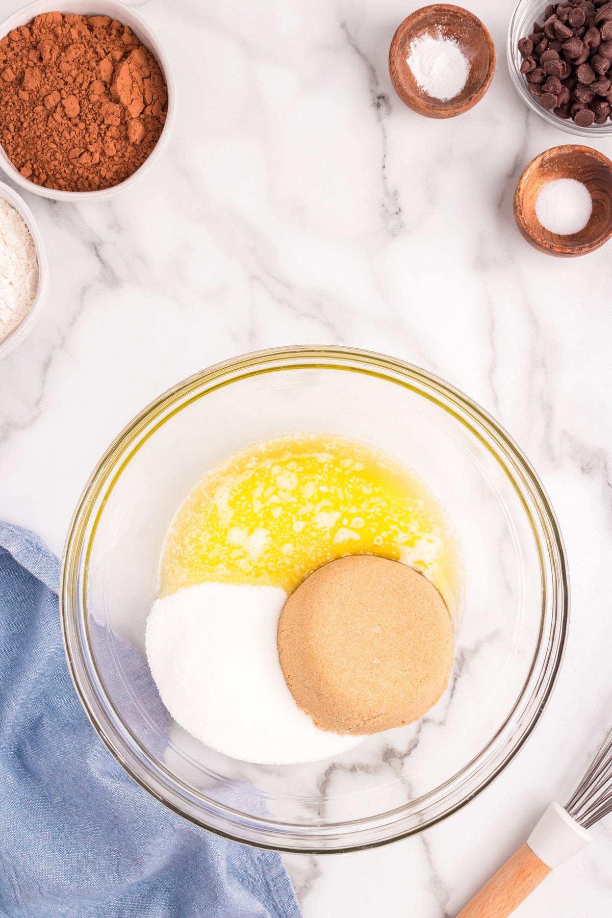 In a mixing bowl, combine melted butter, and both sugars until smooth.