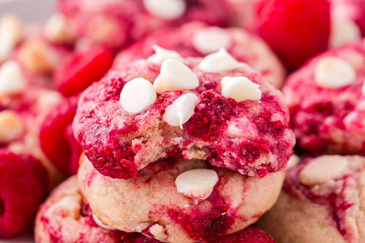 White Chocolate Raspberry Cookies stacked with one bite taken