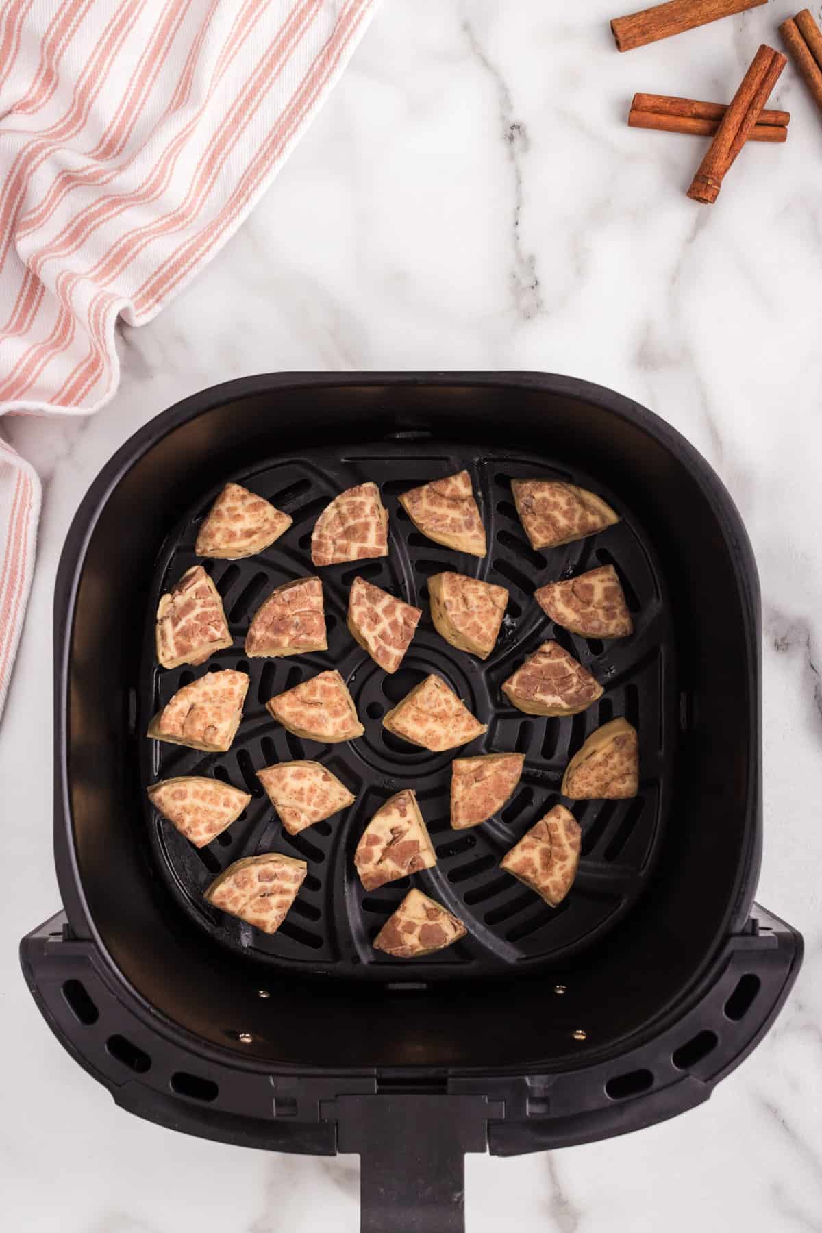 Spray the Air Fryer basket and place the quarters in the air fryer and cook.