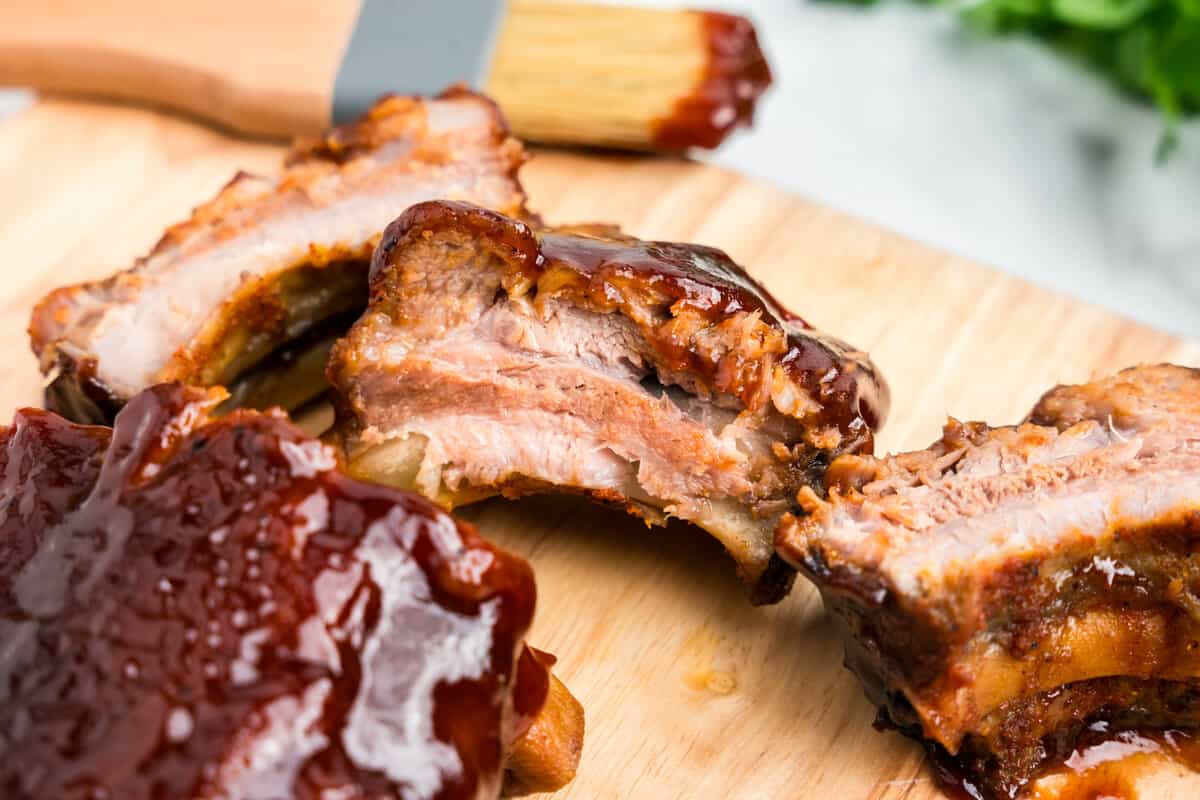 Oven Baked Ribs with bbq sauce on cutting board