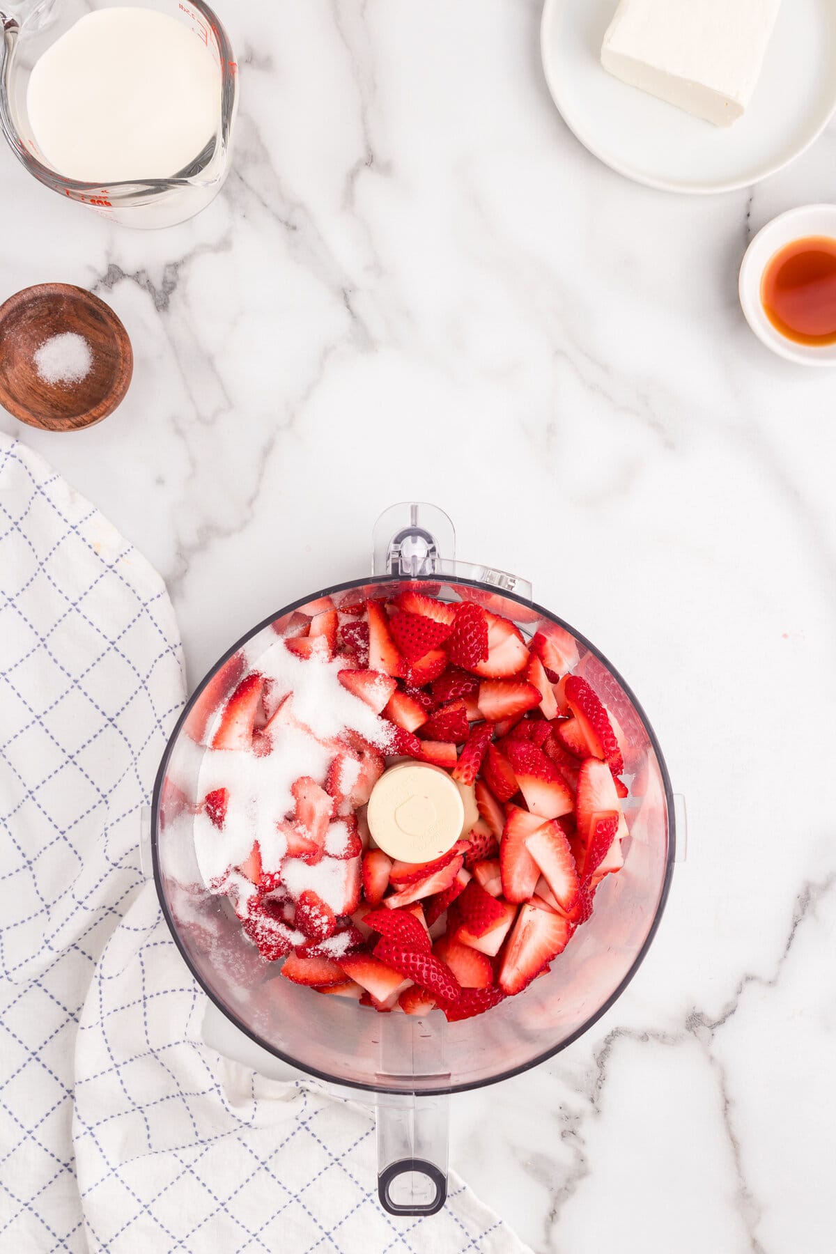 Strawberries and sugar in food processor to make the puree for the Strawberry Mousse recipe