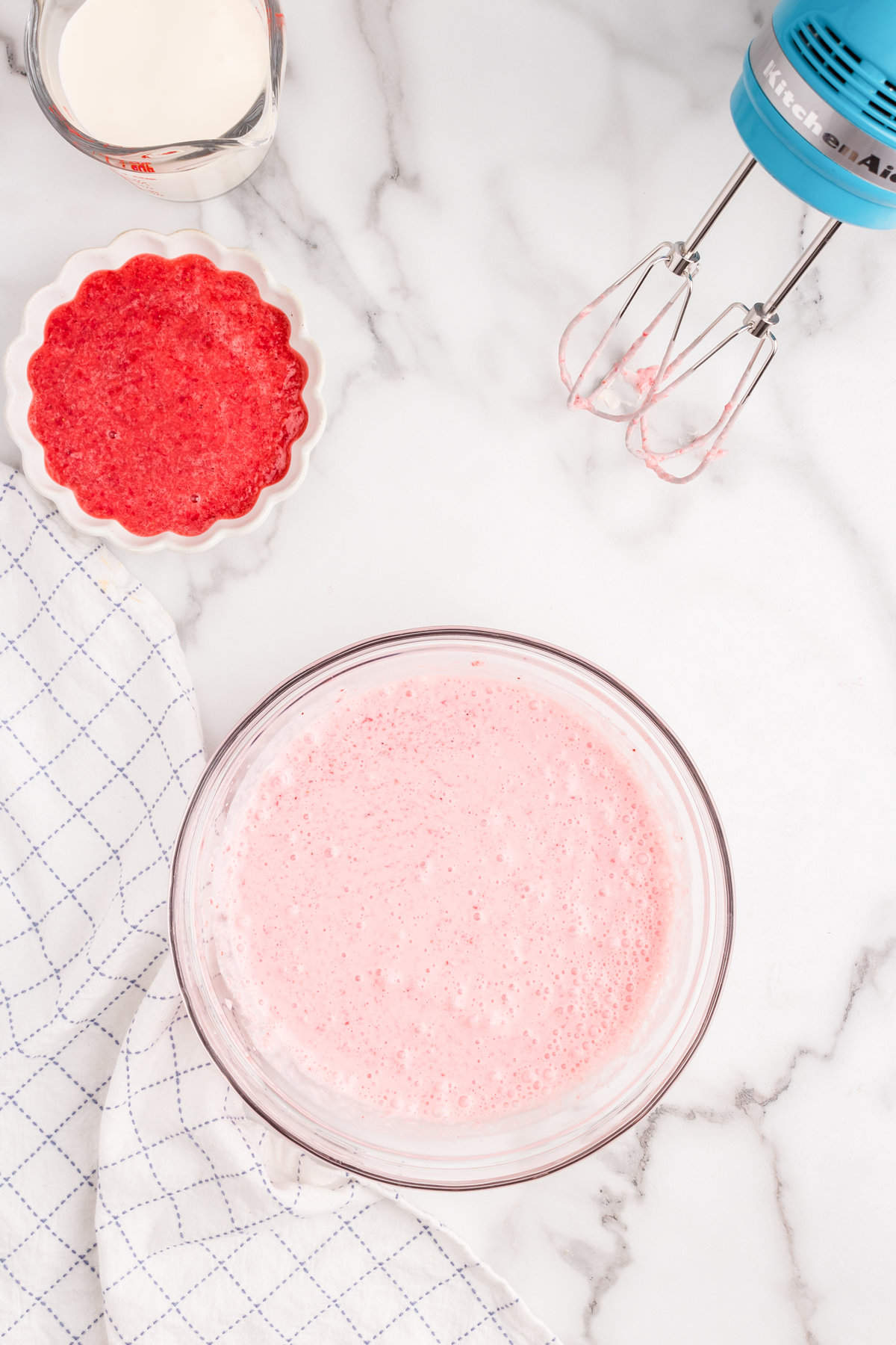 Addinging in some strawberry puree to the whipped mixture for Strawberry Mousse